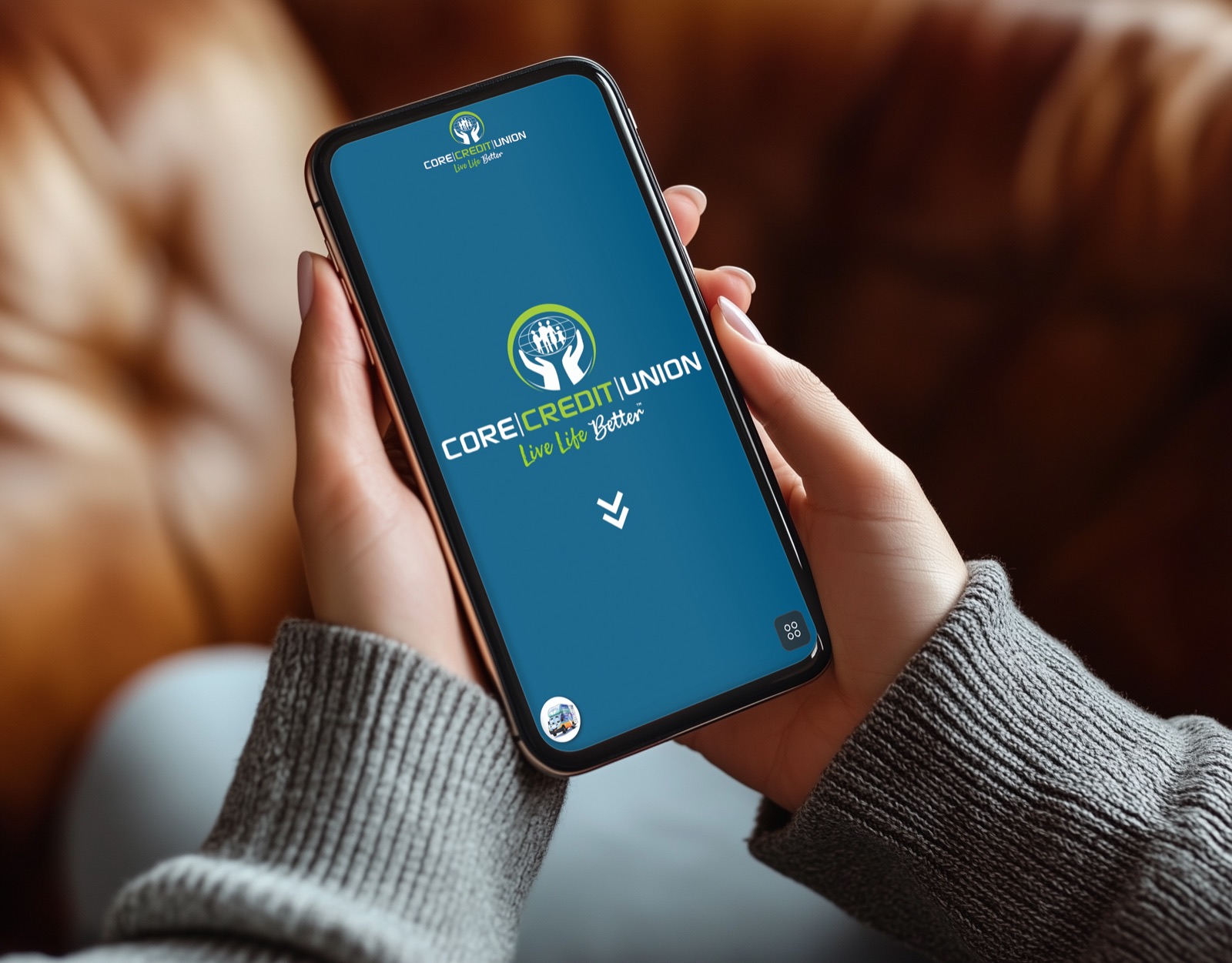 Hand holding a smartphone showing the Core Credit Union mobile experience